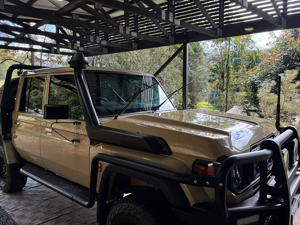 Detailed Toyota LandCruiser 70 Series with a glossy bonnet, parked under a carport
